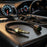 Sharp-focus image of the small temperature sensor against a blurred dashboard with gauges, under warm lighting.