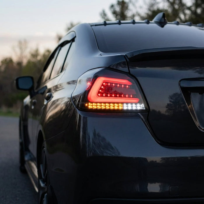 Side view of 2015-2021 Subaru WRX STI VA with red C-shape LED tail lights, matte black housing, twilight outdoor scene emphasizing sleek rear design.
